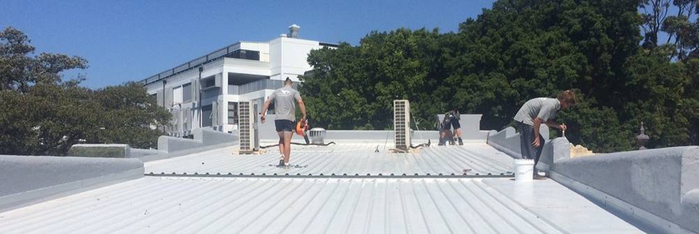 Roofers maintaining a roof.